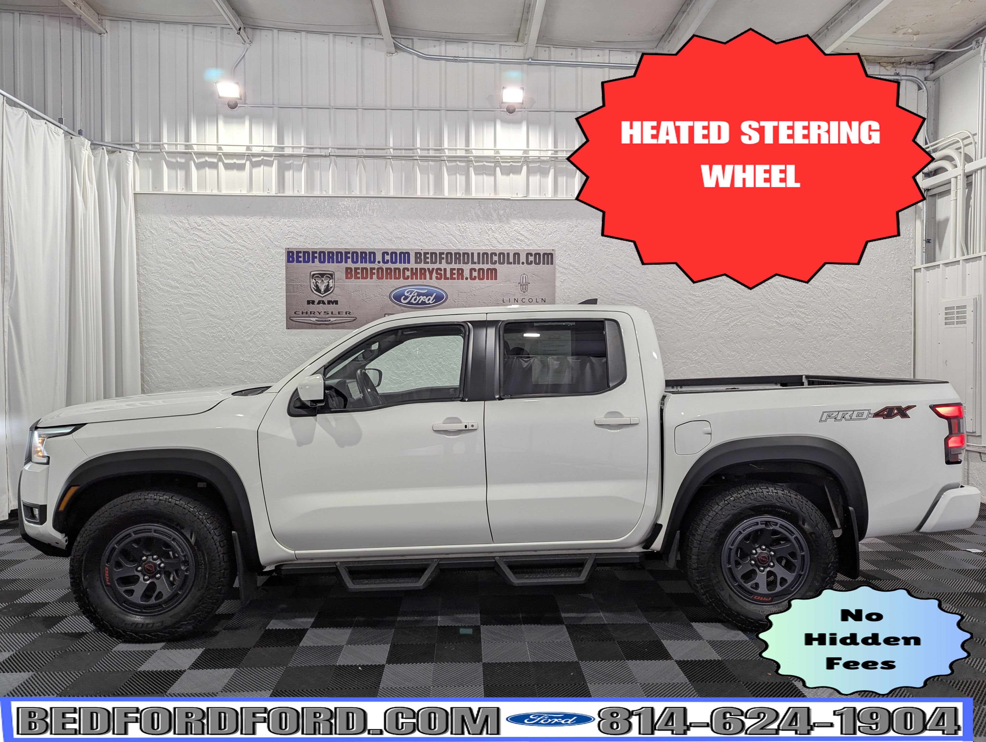 2025 Nissan Frontier PRO-4X 4x4 in Glacier White — front three-quarter view