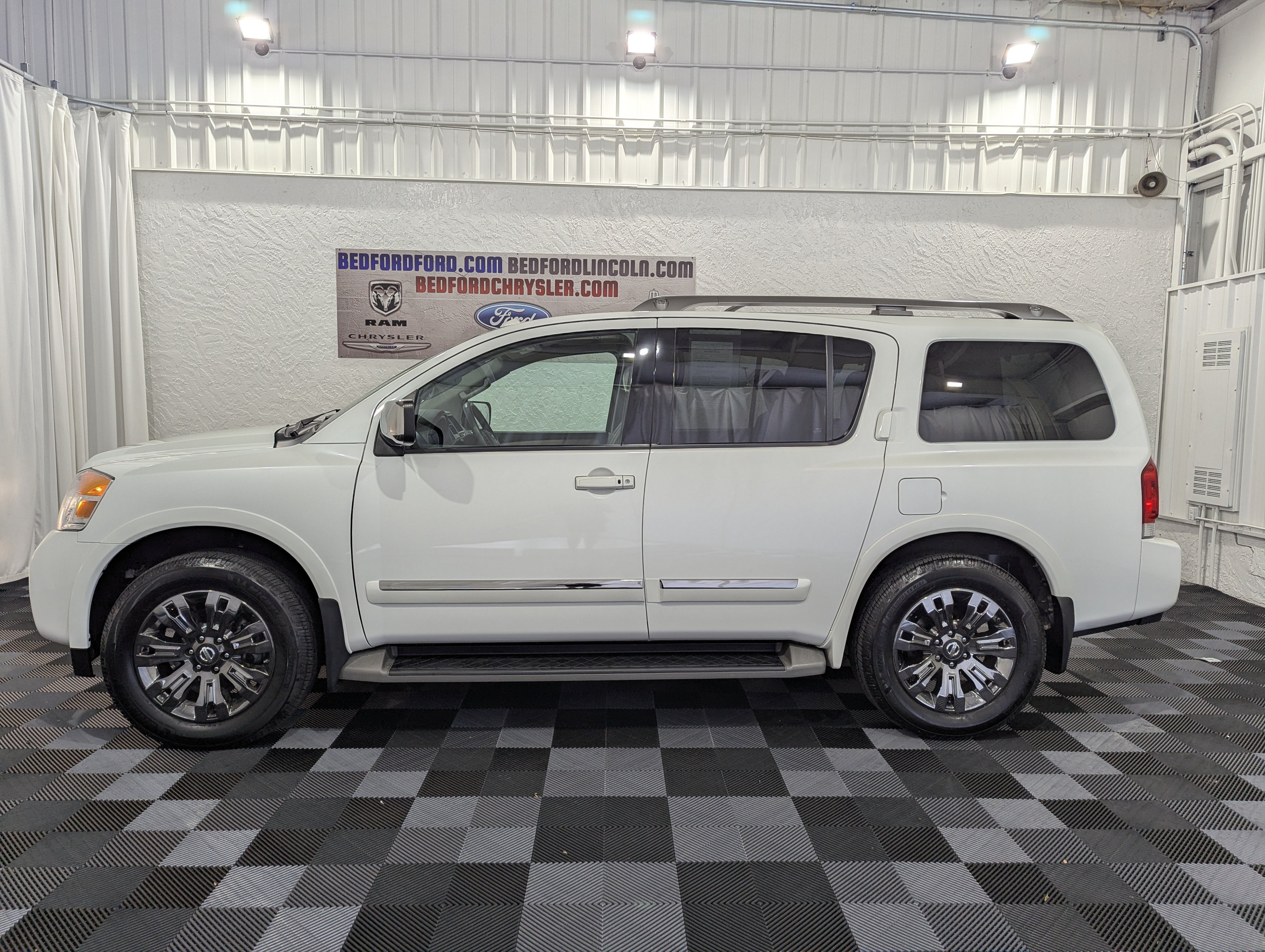 2015 Nissan Armada Platinum in Pearl White — front three-quarter view